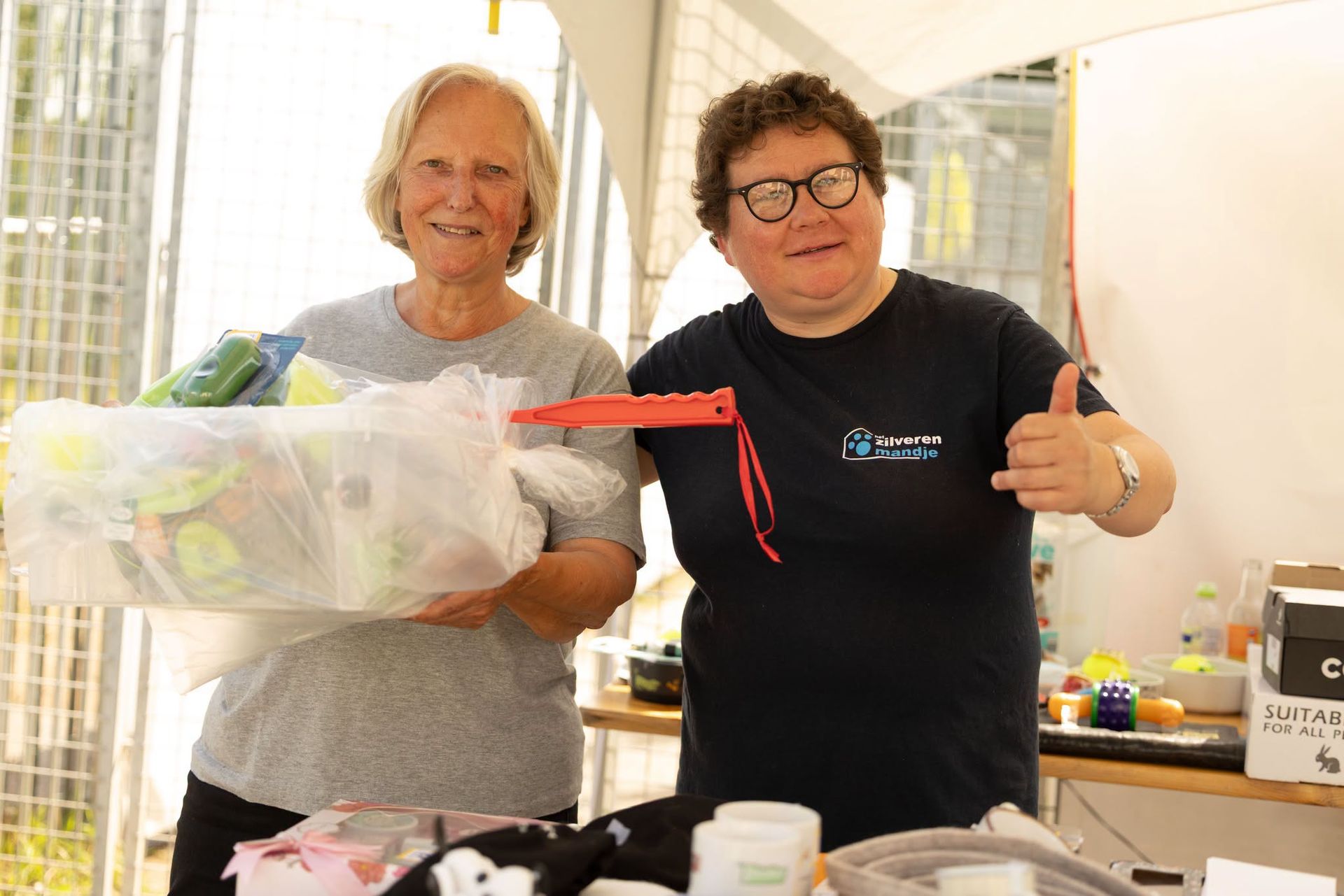 Twee vrijwilligers aan de stand van Het Zilveren Mandje